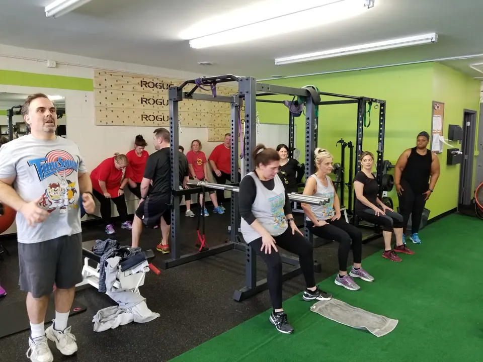 Small group doing wall sits with a coach at Health Targeted Solutions in Clinton Township, MI